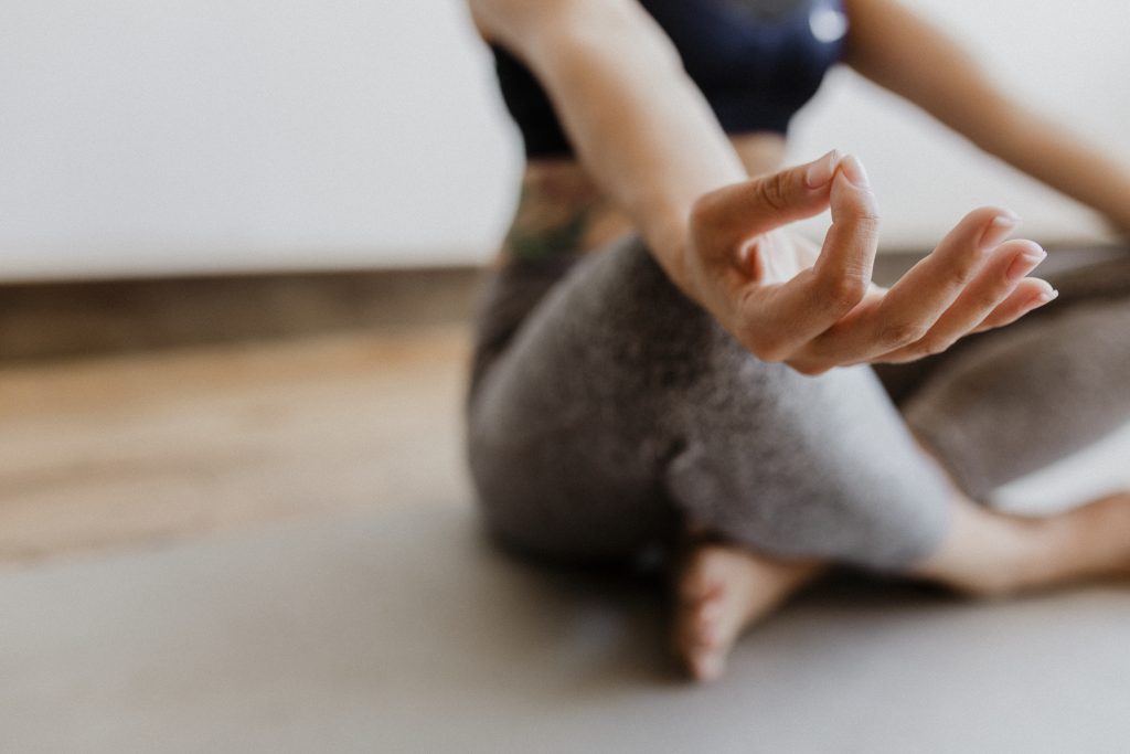 girl doing yoga meditation on yoga mat