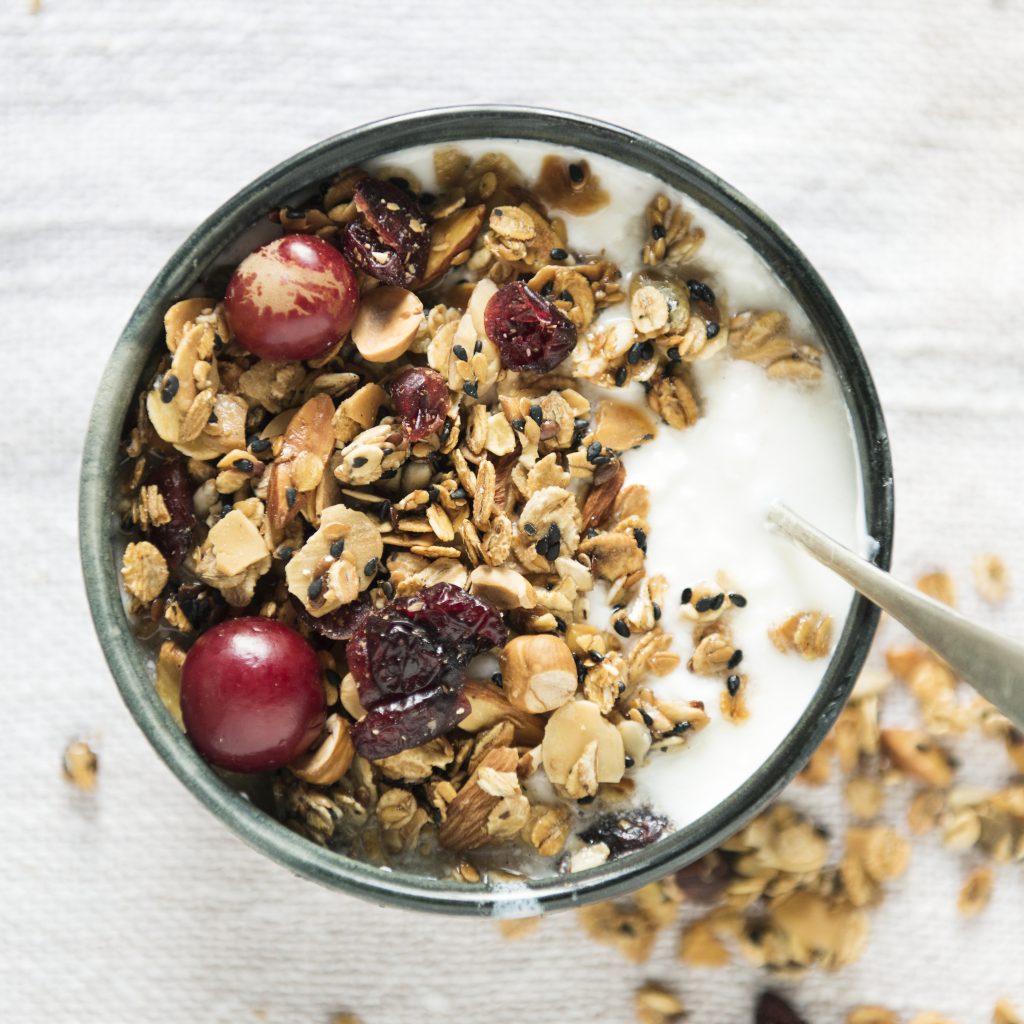 granola and cherries in yogurt cup
