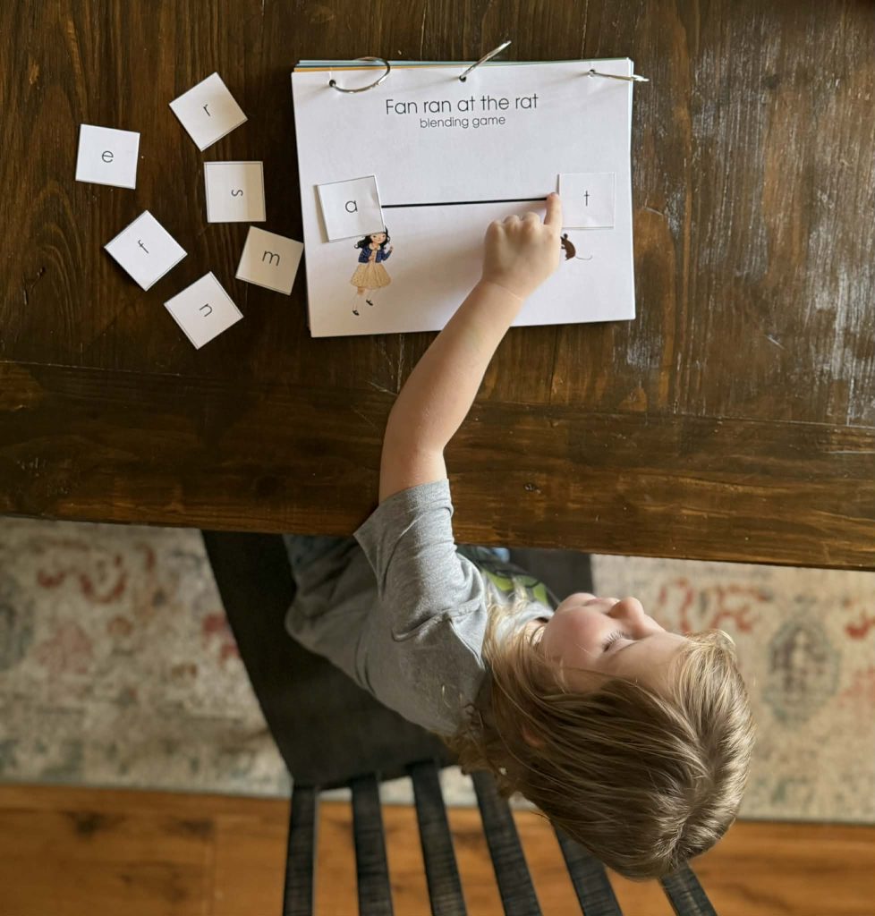 Young child using a hands-on phonics blending activity from Dash Into Learning